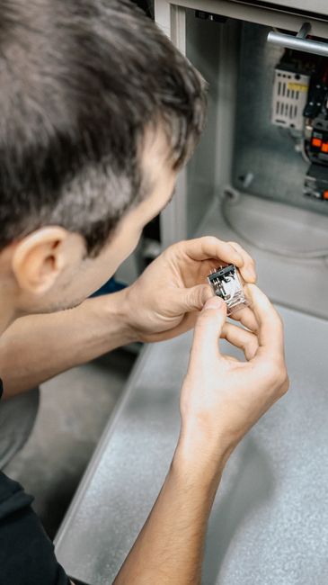 Maintenance technician inspecting industrial electronic equipment